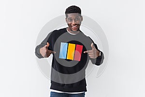 Handsome African American man posing in black sweatshirt on a white background. Youth street fashion photo with afro