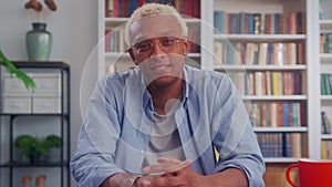 Handsome African American Man Smiling Charmingly at Desk in Living Room