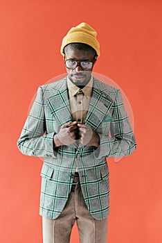 handsome african american man in vintage glasses and jacket