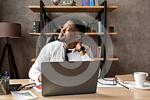 Handsome african business man tired after work in modern office