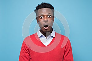 Handsome african man looking in shock and frustration at the camera