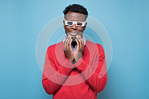 Handsome african young man in 3-d glasses watching melodrama crying