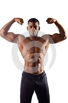 Handsome afro man shows body and abdominal muscles over white background