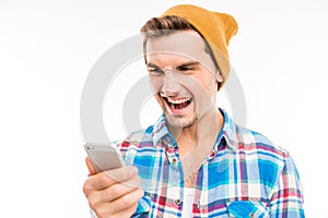 Handsome angry man with hat shouting on the phone