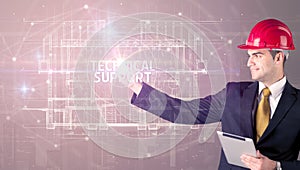 Handsome architect drawing with helmet