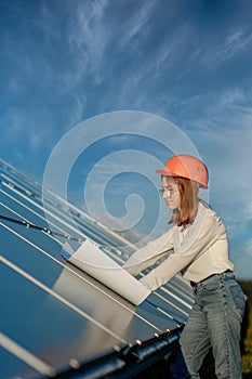 Handsome Architect Woman Examining a Draft Map or Blueprint Project Plan, Worker Activity Looking Out in Photovoltaic