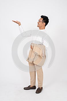 A handsome Asian businessman is opening his palm aside at an empty space on an isolated background