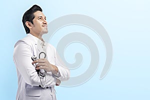 Handsome asian doctor man in white lab coat and stethoscope crossed arms