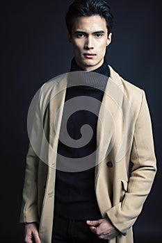 Handsome asian fashion looking man posing in studio on black background, lifestyle modern people concept close up