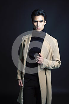 Handsome asian fashion looking man posing in studio on black background, lifestyle modern people concept