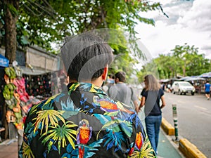 Handsome Asian male walking in Chatuchak Weekend Market Bangkok