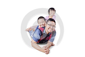 Handsome Asian man pickabacking with his children