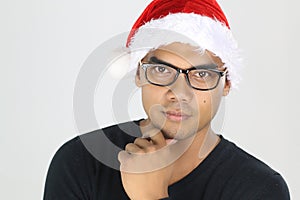 Handsome asian man wearing glasses and santa hat