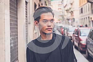 Handsome Asian model posing in the city streets