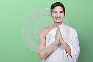 Handsome asian muslim with ihram clothes standing