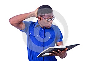 Handsome astonished young businessman reading the notebook