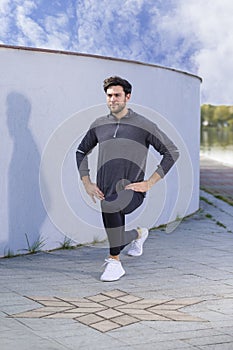 Handsome Athlete Male Runner During Sporty Fit Young Man Jogging by River Bank Training While Stretching