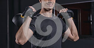 Handsome athletic guy workout with kettlebell