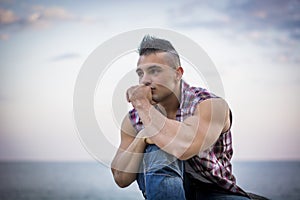 Handsome Athletic Man Looking Away Against Sky