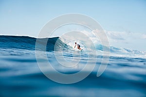 handsome athletic man surfing