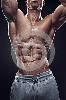 Handsome athletic man working out with dumbbells