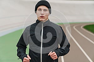 Handsome athletic sportsman running while working out