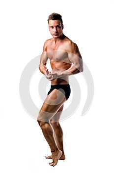 Handsome athletic young man in bodybuilder pose, isolated