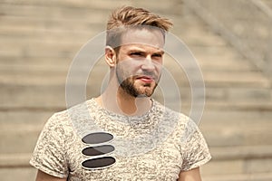 Handsome and attractive. Handsome man in summer style on sunny day. Caucasian guy with sexy beard on unshaven handsome