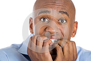 Handsome bald man scared and afraid with fingers in mouth