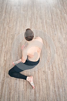 Handsome ballet dancer sitting on a splits