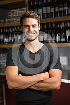 Handsome bar tender standing behind his counter