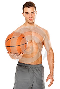 Handsome basketball player holding ball on white