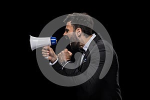 Handsome bearded angry businessman yelling in megaphone