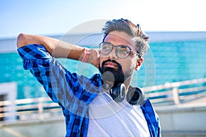 Handsome bearded brunette arabian man listen musics outdoor street