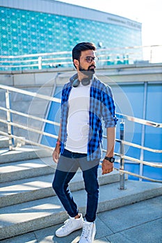 Handsome bearded brunette arabian man listen musics outdoor street