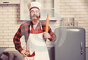 Handsome bearded cheef cook prepairing spaghetti on a kitchen. Chef cooks meal.