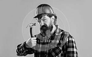 handsome bearded guy with beard and moustache hold hammer, building