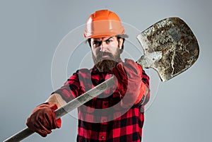 handsome bearded guy with beard and moustache hold shovel, laborer