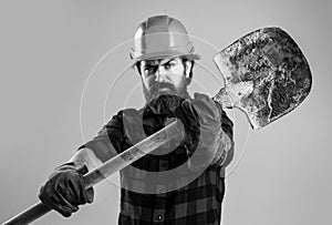 handsome bearded guy with beard and moustache hold shovel, laborer