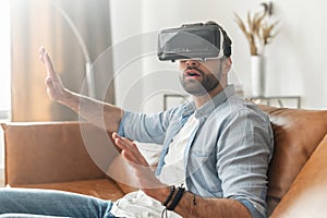 Handsome bearded guy wearing VR goggles