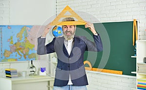 Handsome bearded man in classroom chalkboard. Modern teaching method. Just in theory. Communicative skills. Good luck photo