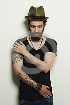 Handsome bearded man in hat.Brutal boy with tattoo photo