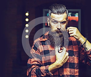 Handsome bearded man hipster with long beard. Bearded man, bearded male. Portrait of stylish man beard. Barber scissors