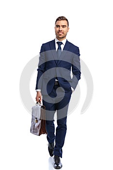 handsome bearded man in navy blue suit holding hand in pocket