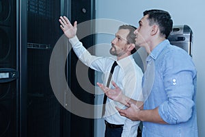 Handsome bearded man pointing at the data server