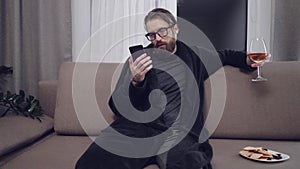 Handsome bearded man relaxing on sofa