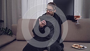 Handsome bearded man relaxing on sofa