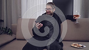 Handsome bearded man relaxing on sofa