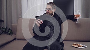 Handsome bearded man relaxing on sofa