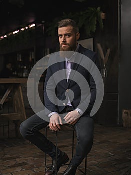 Handsome bearded man is resting in bar